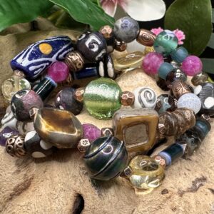 Bohemian Blossom handcrafted wrap bracelet featuring African ox bone beads, gemstones, Czech glass, handmade clay beads, copper accents, recycled glass, and ceramic flower focal bead.