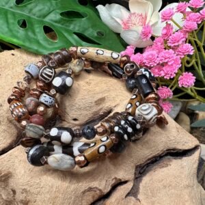 Handcrafted Nomad Spirit wrap bracelet featuring African ox bone, Krobo glass, natural stone, clay, coconut shell, and copper by Boho By Shae